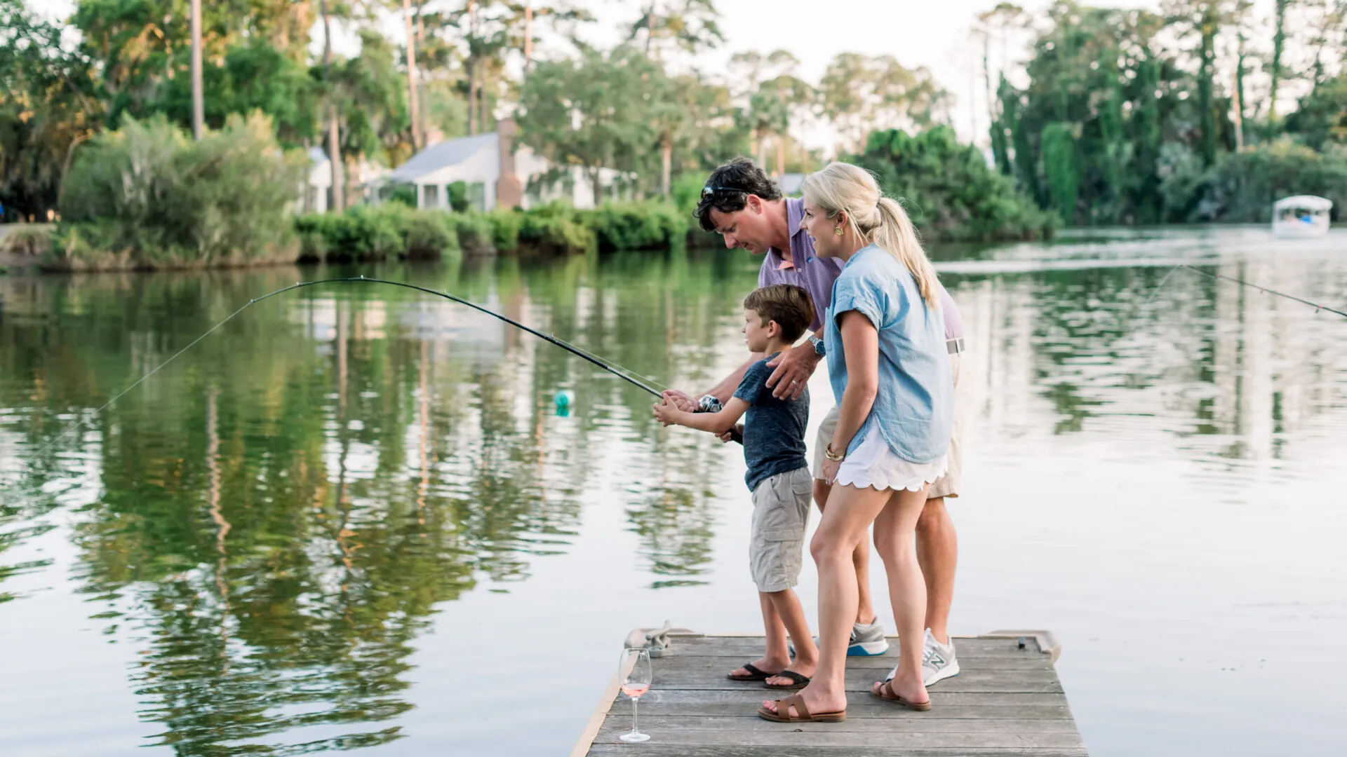 family fishing on dock