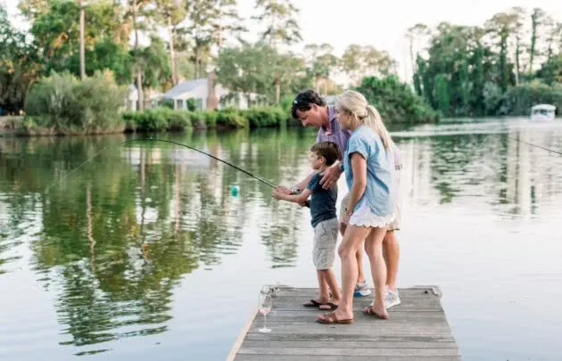 family fishing on dock