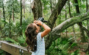 Girl looking through binoculars