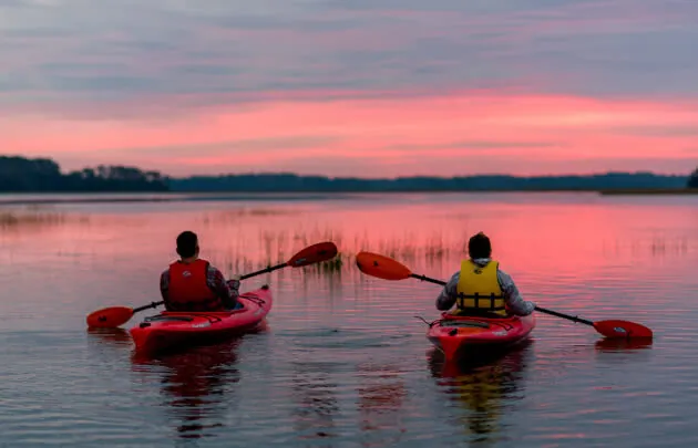 People Kayaking at Sunset at Montage Palmetto Bluff