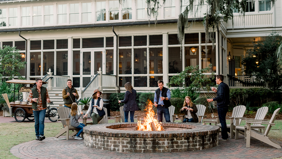 People roasting s'mores outside at Montage Plametto Bluff