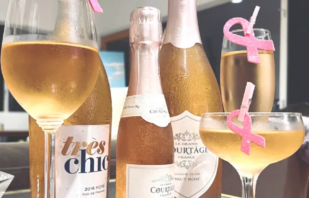 Champagne bottles and glasses on a glass table