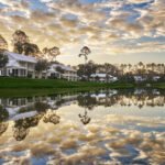 Guest Houses overlooking water with clouds above