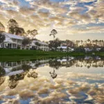 Guest Houses overlooking water with clouds above