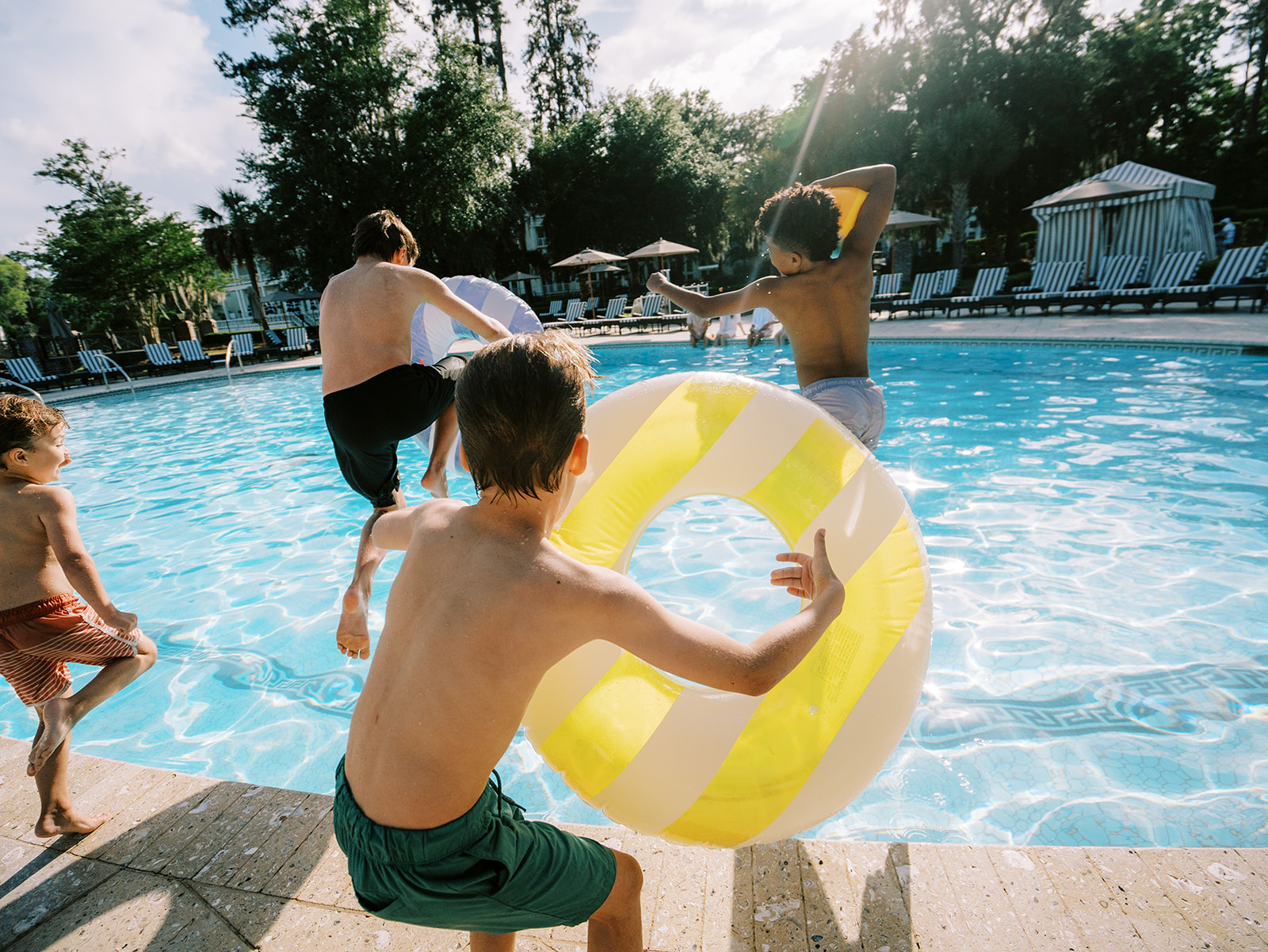Children jumping into pool