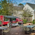 Tables outdoor in front of FLAME pizza