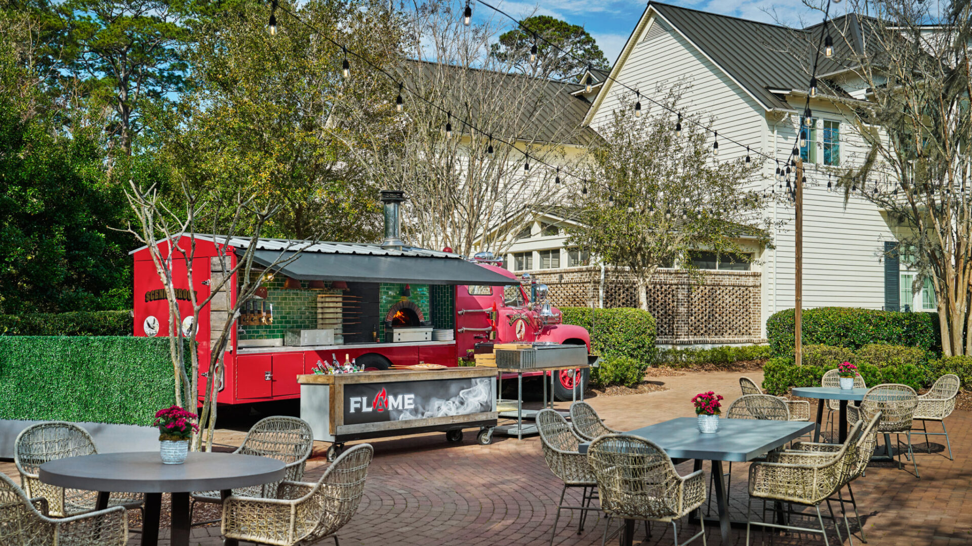 Tables outdoor in front of FLAME pizza
