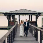 bride & Groom walking down dock after wedding