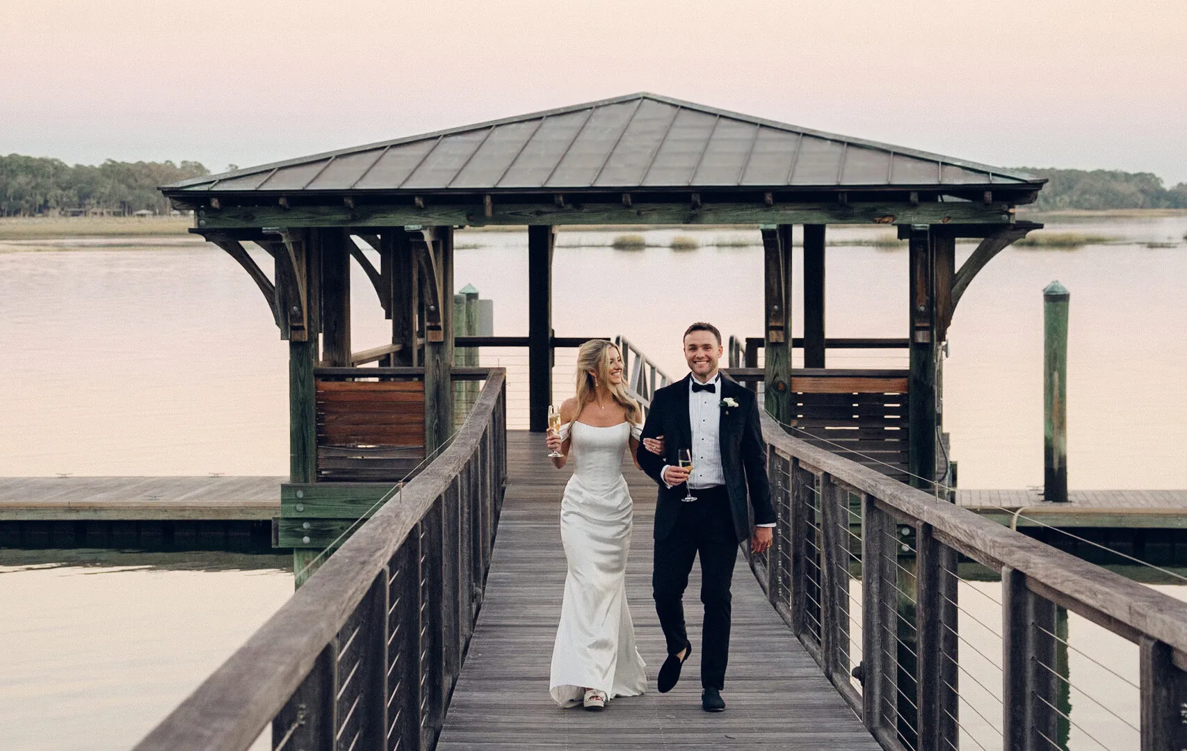 bride & Groom walking down dock after wedding