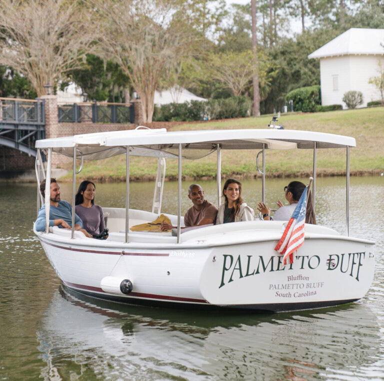 Friends on a boat at Montage Palmetto Bluff