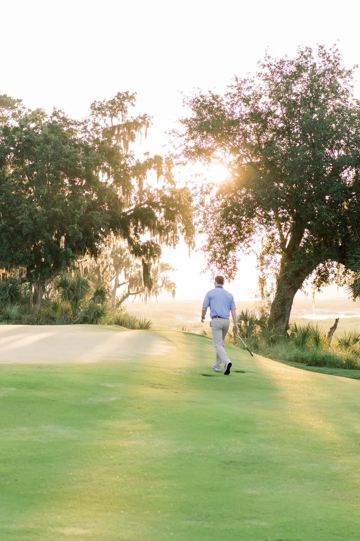 A man walking on the golf course.