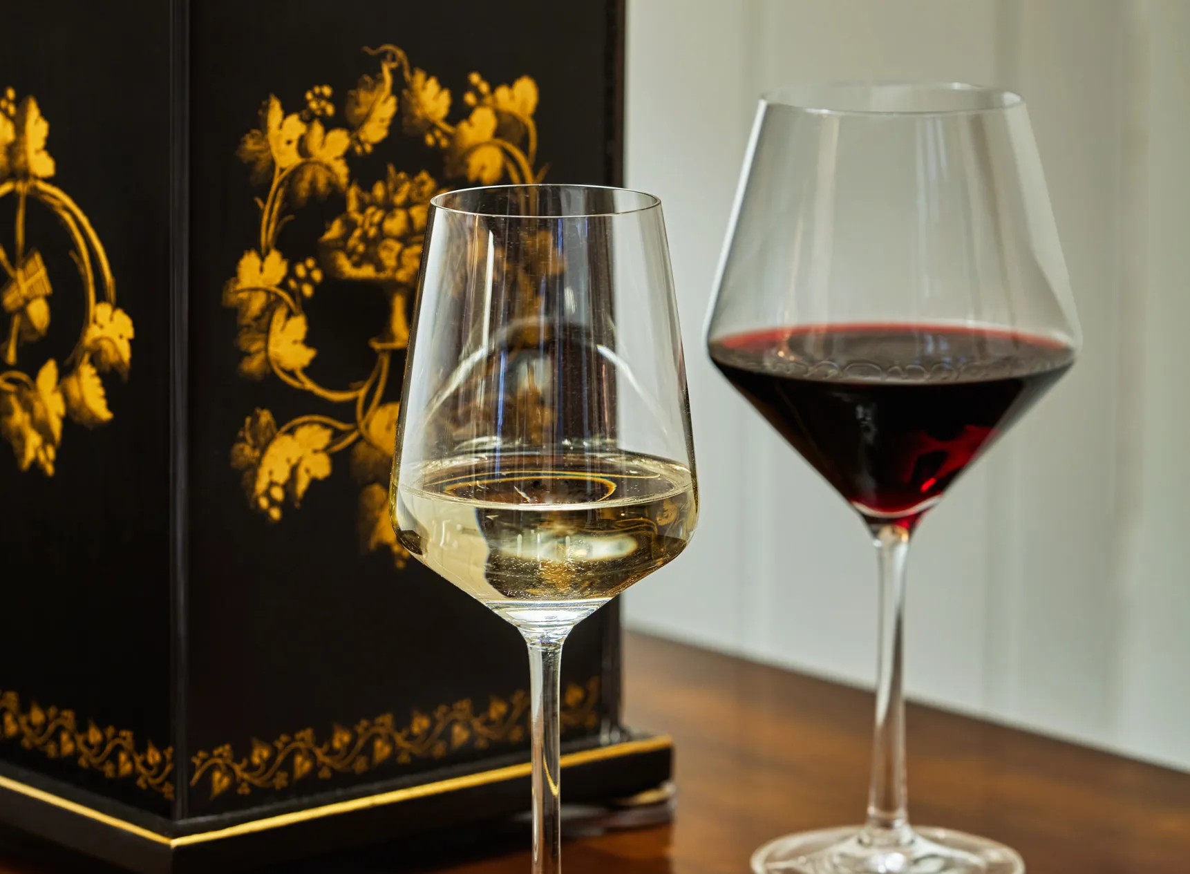 Two glasses of with on a wooden table