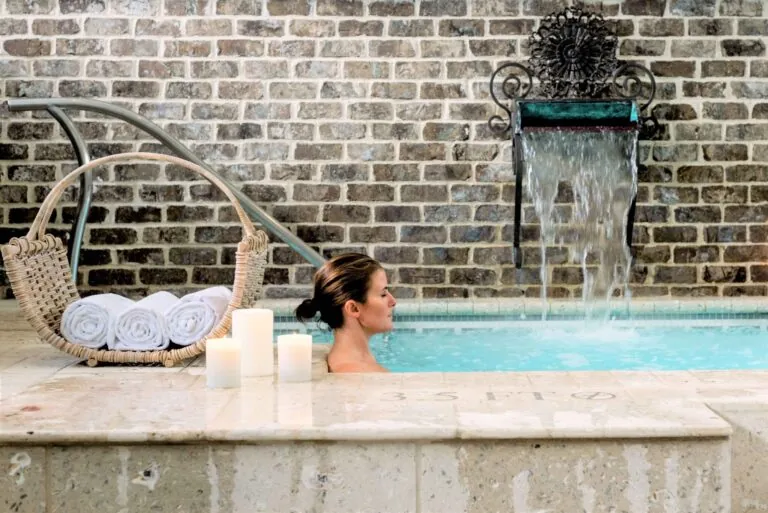 Woman sitting in the indoor pool at Spa Montage Palmetto Bluff