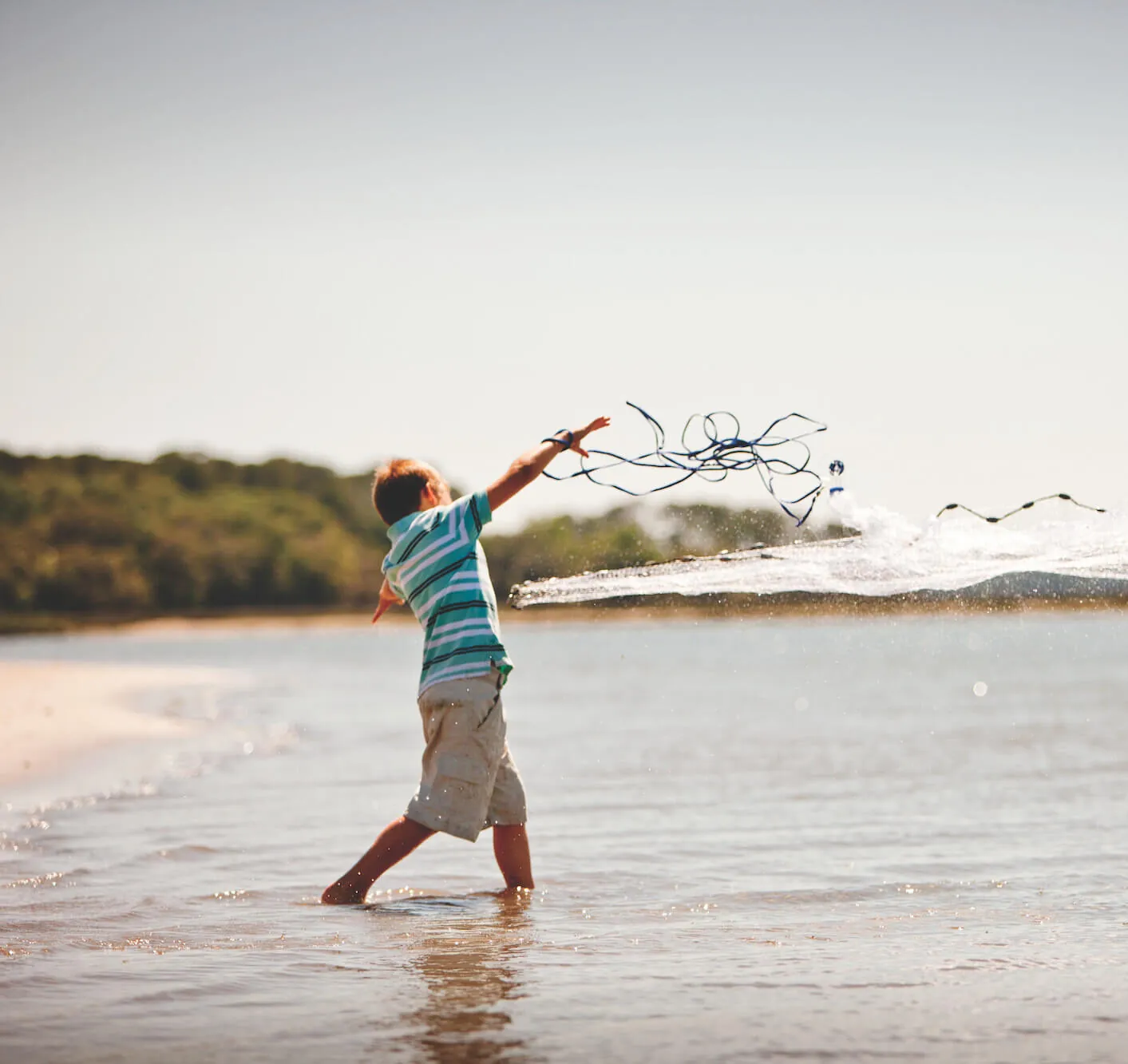 A boy playing on the beach.